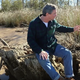 AL.com reporter Ben Raines sits among the wreckage that archeologists believe may be the remnants of the Clotilda. (AL.com via YouTube screenshot)